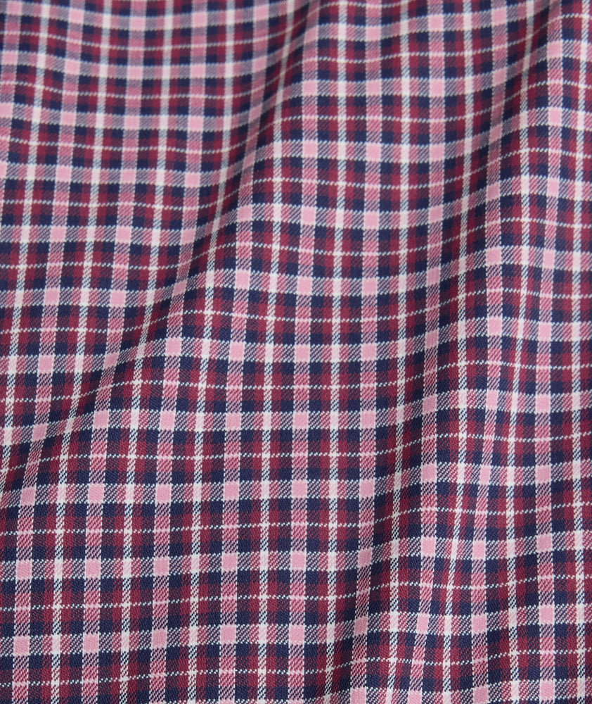 Model is wearing UNTUCKit performance Delune shirt in red.