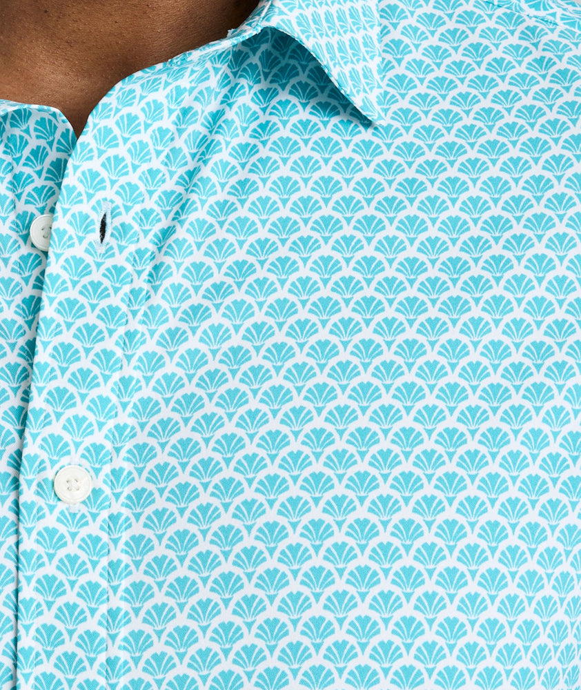 Model is wearing UNTUCKit Abbott performance print short sleeve shirt in teal.