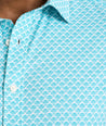 Model is wearing UNTUCKit Abbott performance print short sleeve shirt in teal.