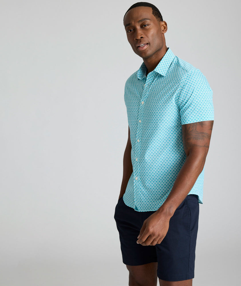 Model is wearing UNTUCKit Abbott performance print short sleeve shirt in teal.