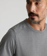 Model is wearing UNTUCKit Performance Tee in gray.