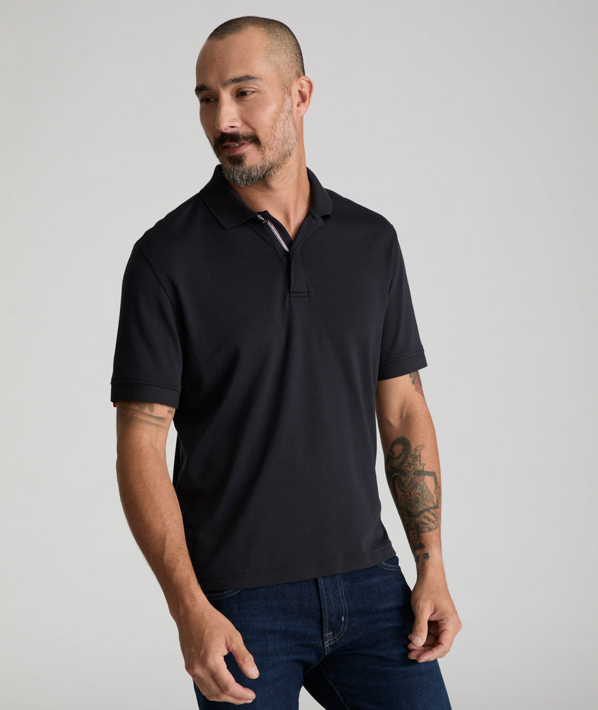 Model is wearing UNTUCKit Wrinkle-Free Damaschino Polo in black.