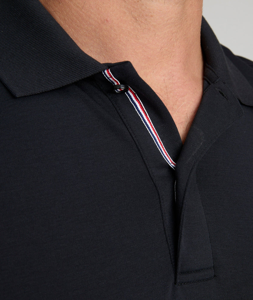 Model is wearing UNTUCKit Wrinkle-Free Damaschino Polo in black.