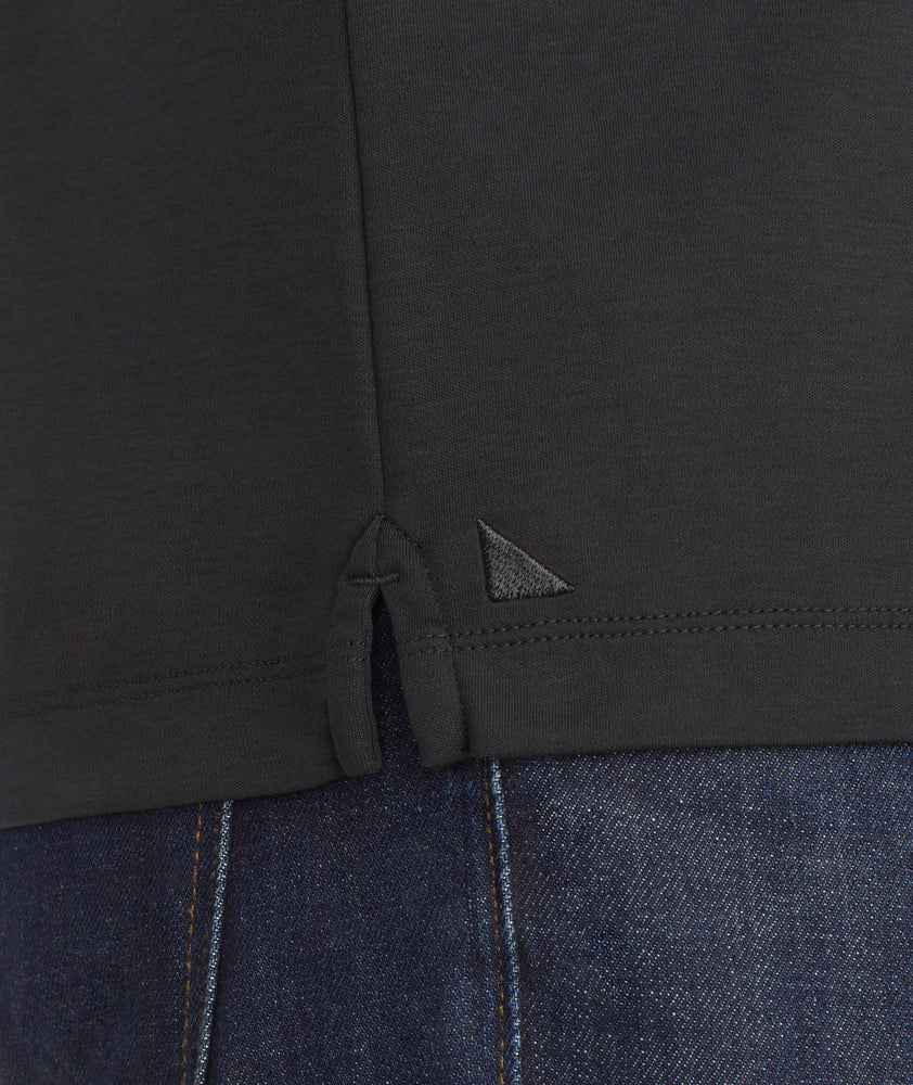 Model is wearing UNTUCKit Wrinkle-Free Damaschino Polo in black.