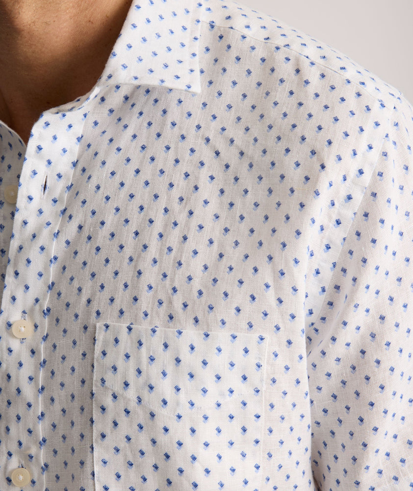 Model is wearing UNTUCKit Dixon short sleeve shirt with white grounded Dimond print.