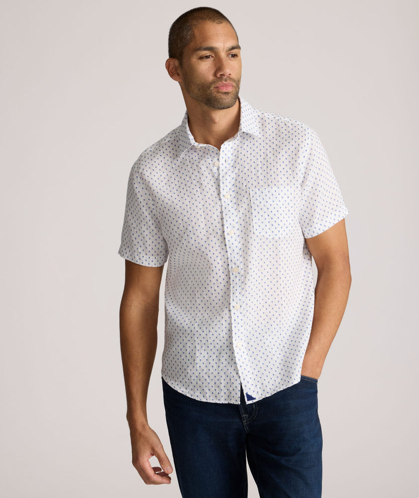 Model is wearing UNTUCKit Dixon short sleeve shirt with white grounded Dimond print.