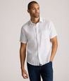 Model is wearing UNTUCKit Dixon short sleeve shirt with white grounded Dimond print.