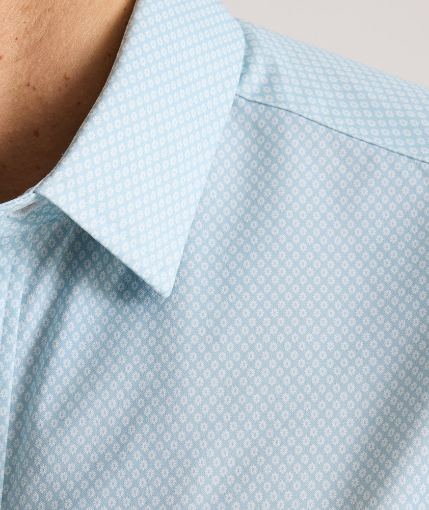 Model is wearing UNTUCKit Falkirk performance shirt in blue print.