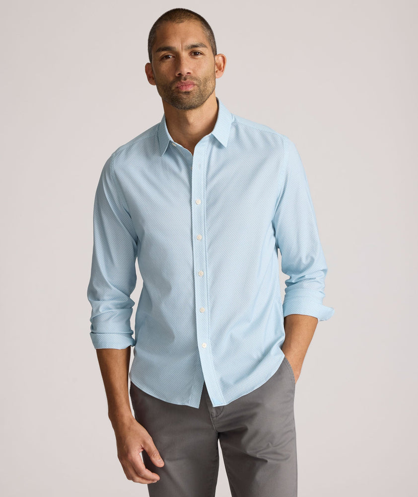 Model is wearing UNTUCKit Falkirk performance shirt in blue print.