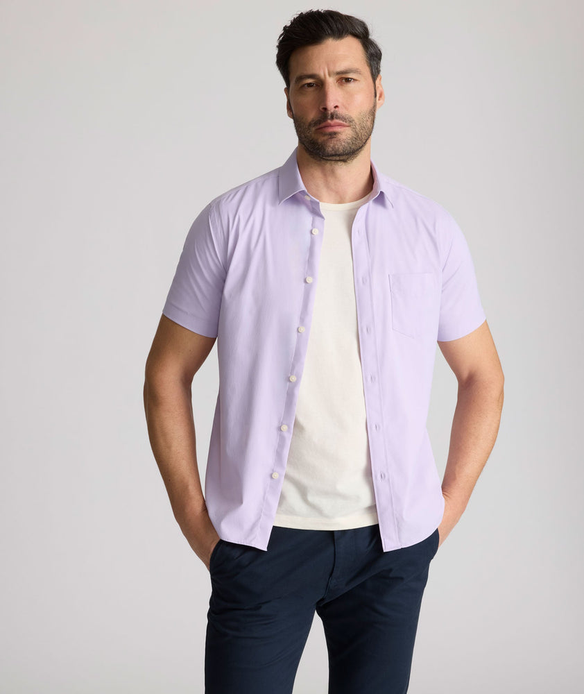 Model is wearing UNTUCKit Gironde short sleeve performance  shirt in purple.