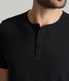 Model is wearing UNTUCKit glera tencel solid black henley.