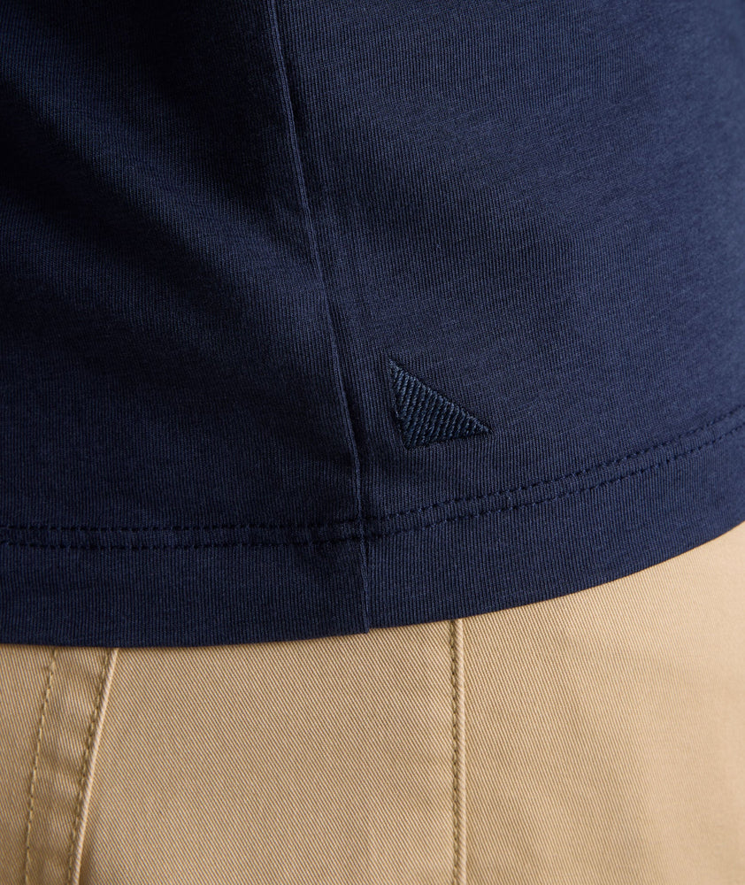 Model is wearing UNTUCKit glera henley in peacoat.