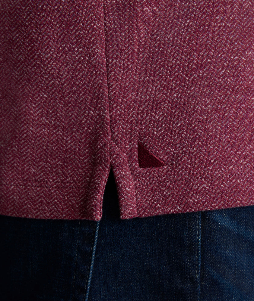 Model is wearing UNTUCKit Harrow Herringbone Henley in Tawny Port.