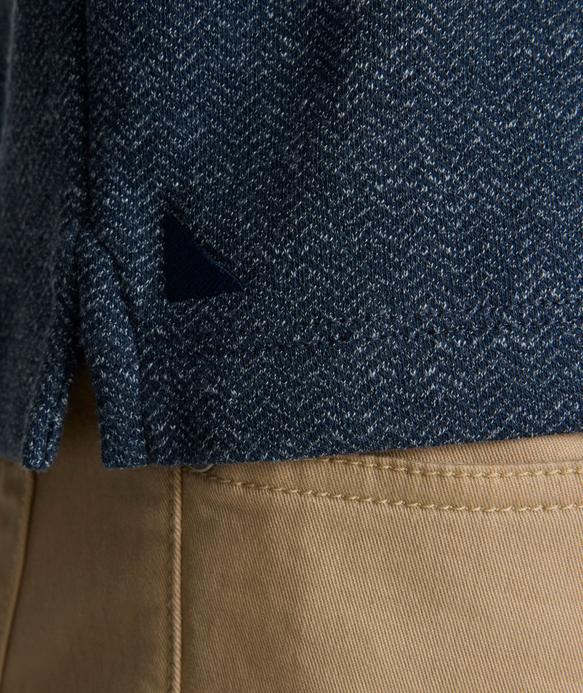 Model is wearing UNTUCKit Harrow Herringbone Henley in Navy.