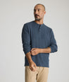 Model is wearing UNTUCKit Harrow Herringbone Henley in Navy.