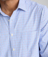 Model is wearing UNTUCKit Kaleb long sleeve performance shirt in light blue and white check.