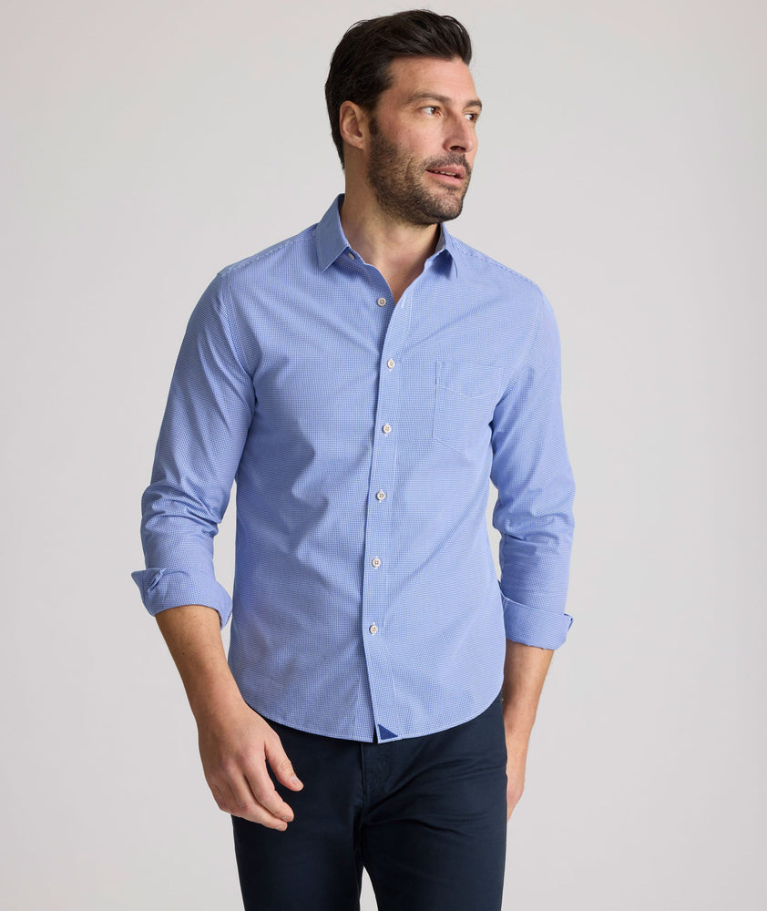 Model is wearing UNTUCKit Kelly wrinkle free shirt in blue gingham.
