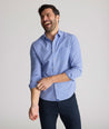 Model is wearing UNTUCKit Kelly wrinkle free shirt in blue gingham.