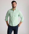 Model is wearing UNTUCKit Kelly wrinkle free shirt in green gingham.