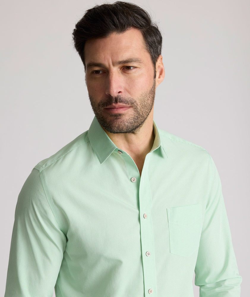 Model is wearing UNTUCKit Kelly wrinkle free shirt in green gingham.