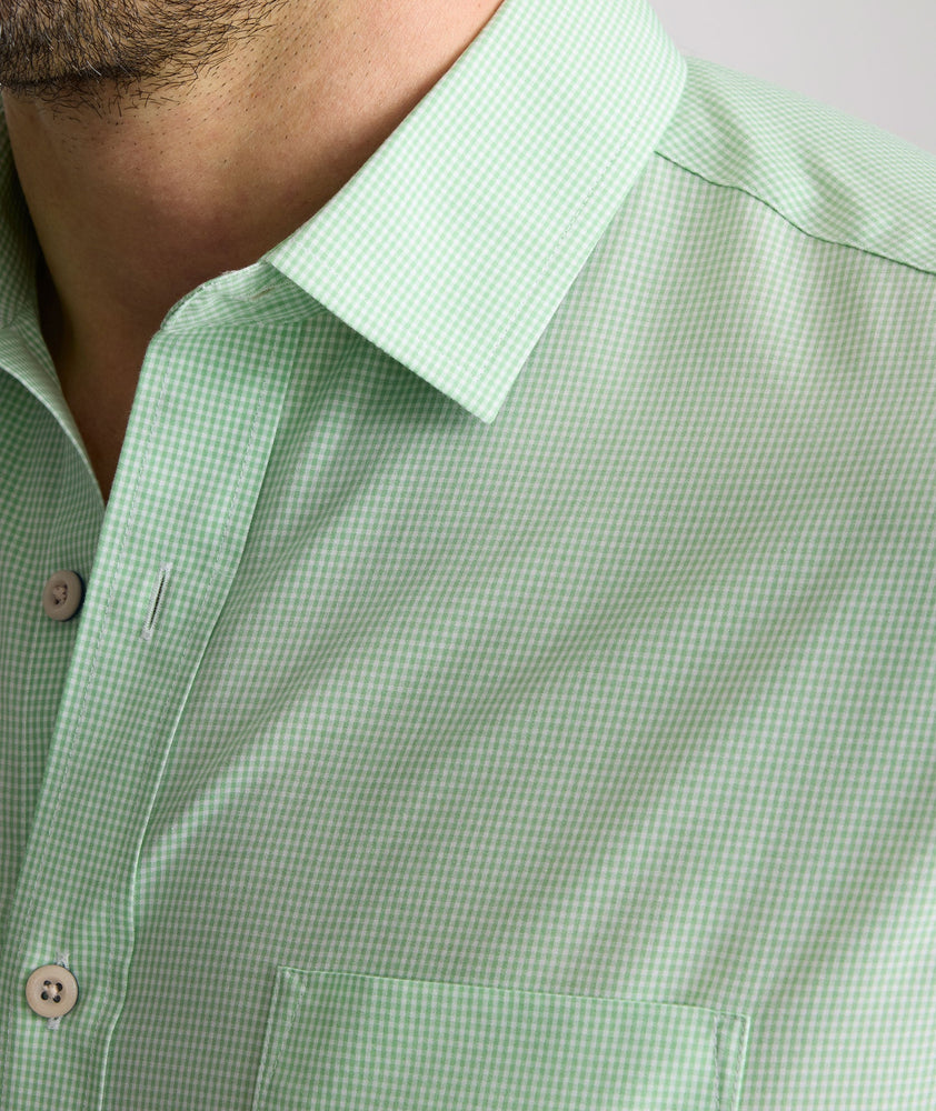 Model is wearing UNTUCKit Kelly wrinkle free shirt in green gingham.