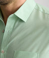 Model is wearing UNTUCKit Kelly wrinkle free shirt in green gingham.