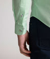 Model is wearing UNTUCKit Kelly wrinkle free shirt in green gingham.