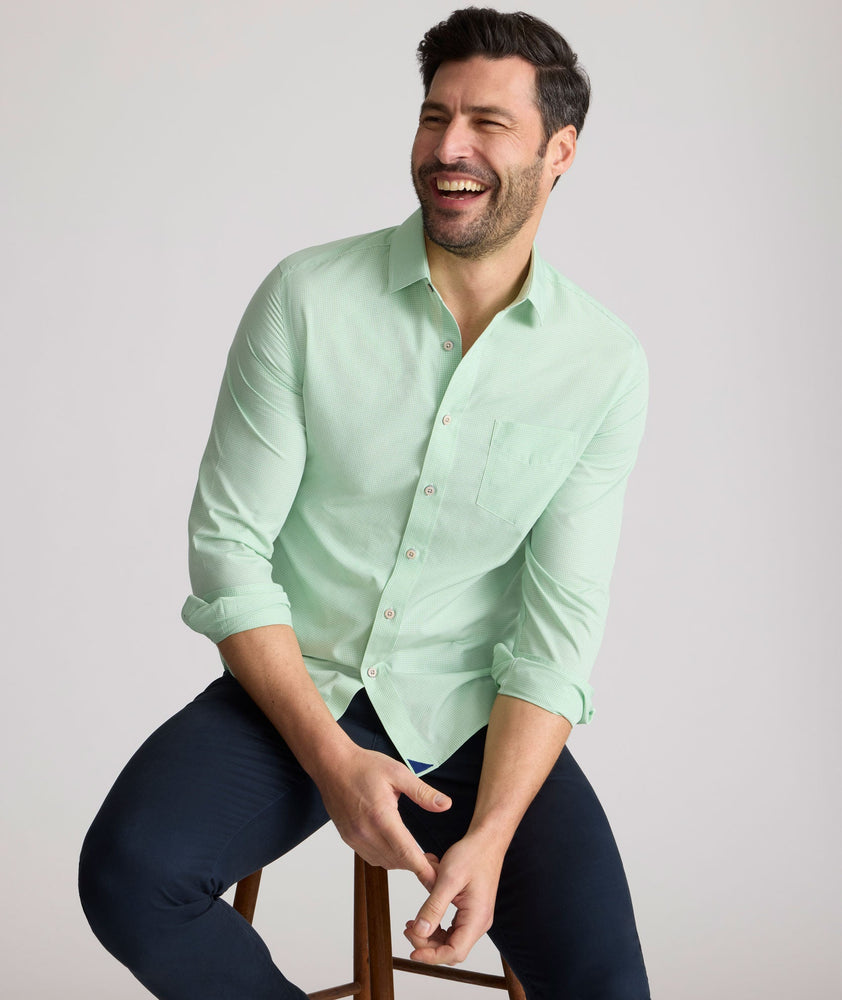 Model is wearing UNTUCKit Kelly wrinkle free shirt in green gingham.