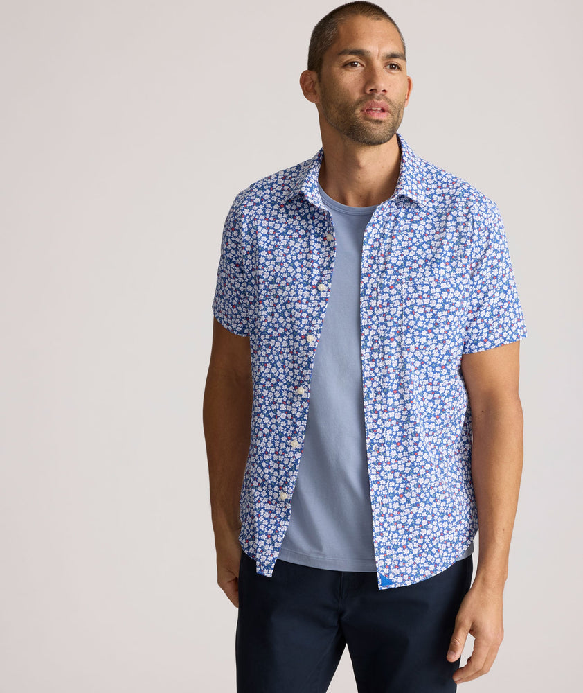 Model is wearing UNTUCKit Kincaid shirt in blue floral print.