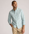 Model is wearing UNTUCKit Quigley wrinkle free shirt in check.
