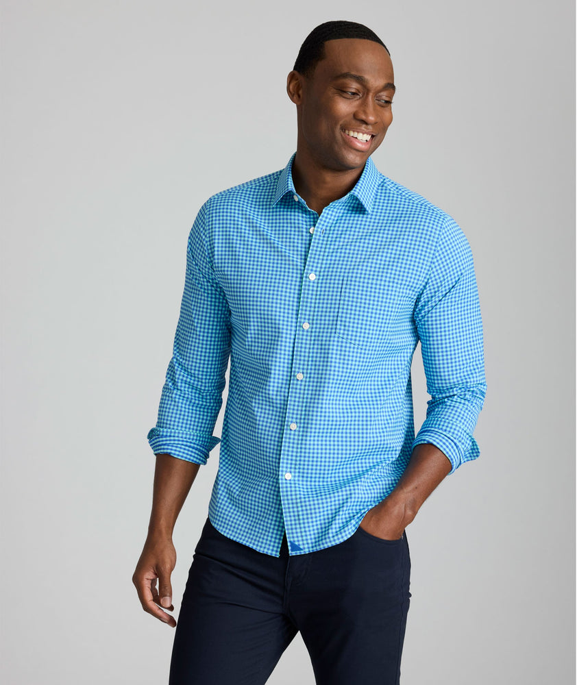 Model is wearing UNTUCKit Quinby performance gingham shirt in blue.