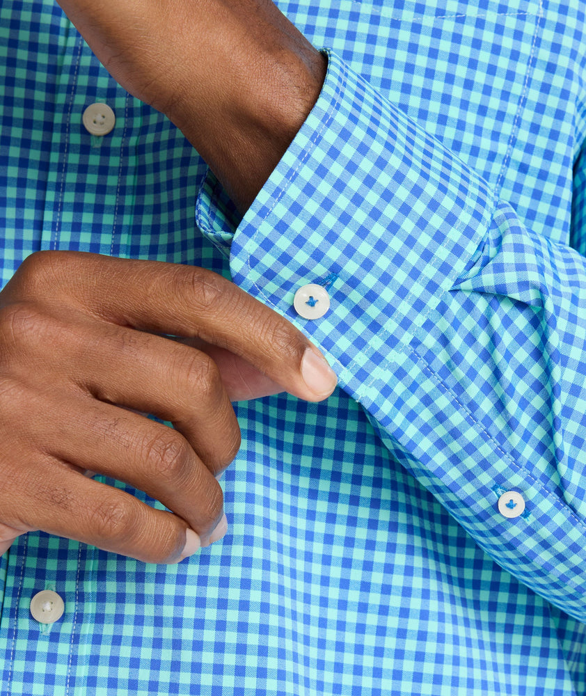 Model is wearing UNTUCKit Quinby performance gingham shirt in blue.