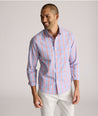 Model is wearing UNTUCKit ravenswood wrinkle free plaid plaid shirt in orange.
