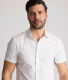 Model is wearing UNTUCKit Rockwell short sleeve cotton shirt.