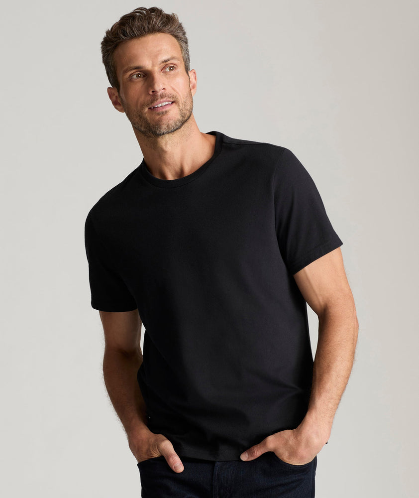 Model is wearing UNTUCKit Saxum ultra soft tee in black.