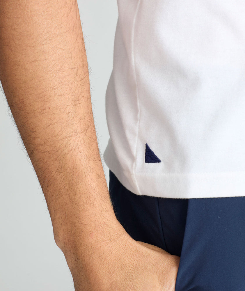 Model is wearing UNTUCKit saxum tee in white.