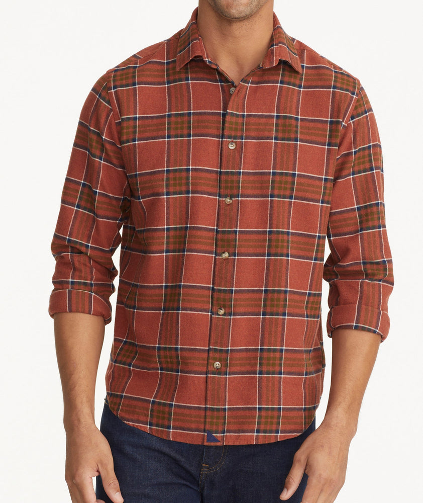 Model is wearing UNTUCKit Flannel Regner Shirt in Burnt Red Plaid.