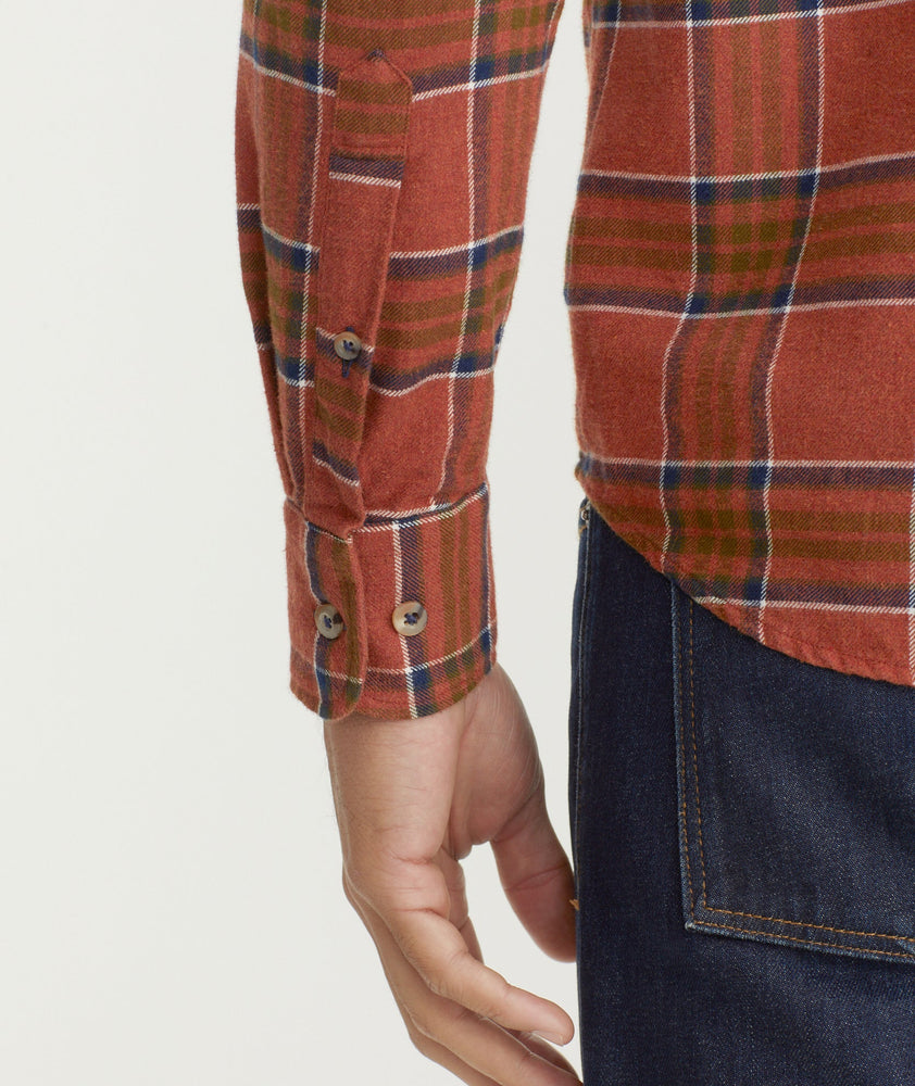 Model is wearing UNTUCKit Flannel Regner Shirt in Burnt Red Plaid.