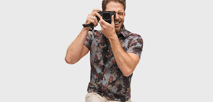 Image of man holding a camera wearing an UNTUCKit shirt