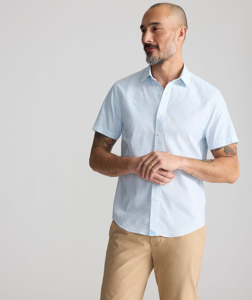 Model is wearing UNTUCKit Performance Short-Sleeve Arundel Shirt in Light Blue Crab Print.