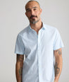 Model is wearing UNTUCKit Performance Short-Sleeve Arundel Shirt in Light Blue Crab Print.