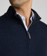 Model is weraring UNTUCKit Belguardo quarter zip in navy.