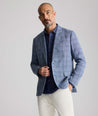 Model is wearing UNTUCKit Linen-Cotton Binkenhall Sport Coat in blue windowpane. 