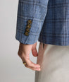 Model is wearing UNTUCKit Linen-Cotton Binkenhall Sport Coat in blue windowpane. 