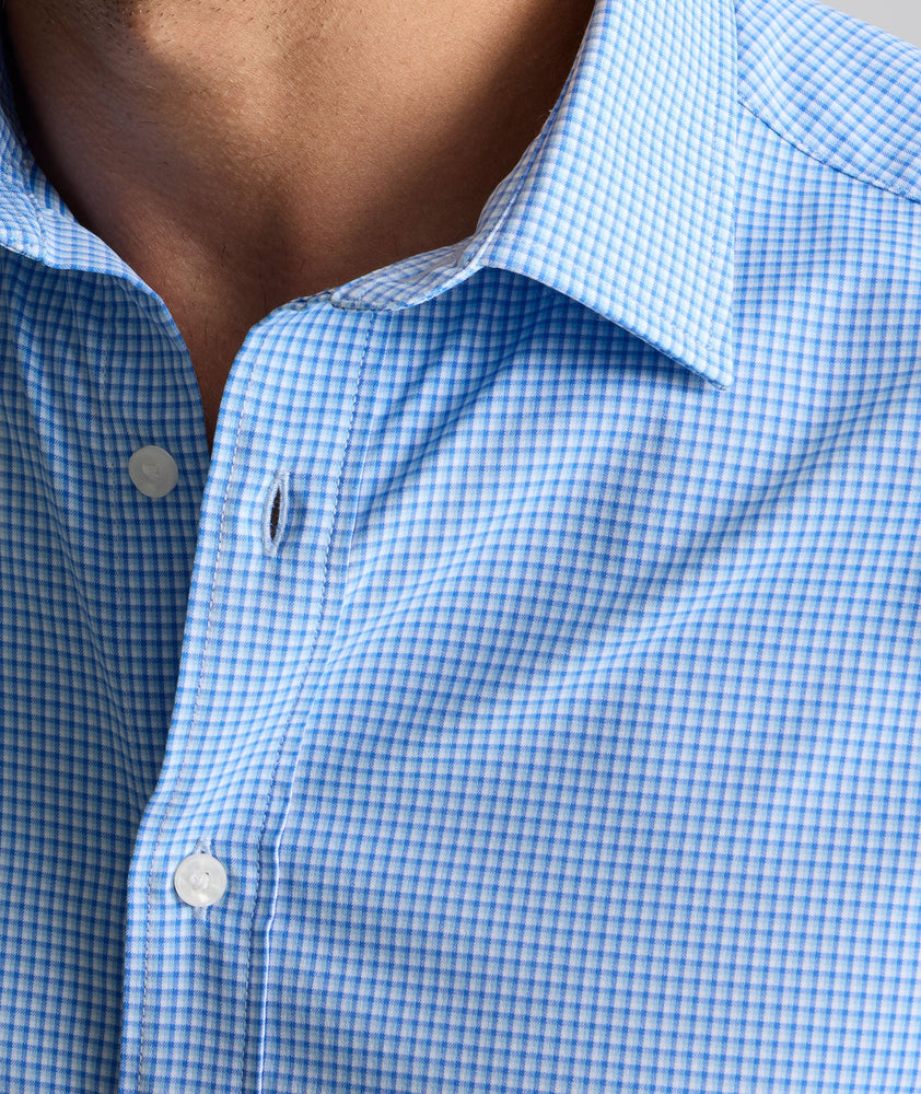 Model is wearing Performance Bravo Shirt in blue. 