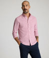 Model is wearing UNTUCKit Cadetto wrinkle-free shirt in rose wine. 