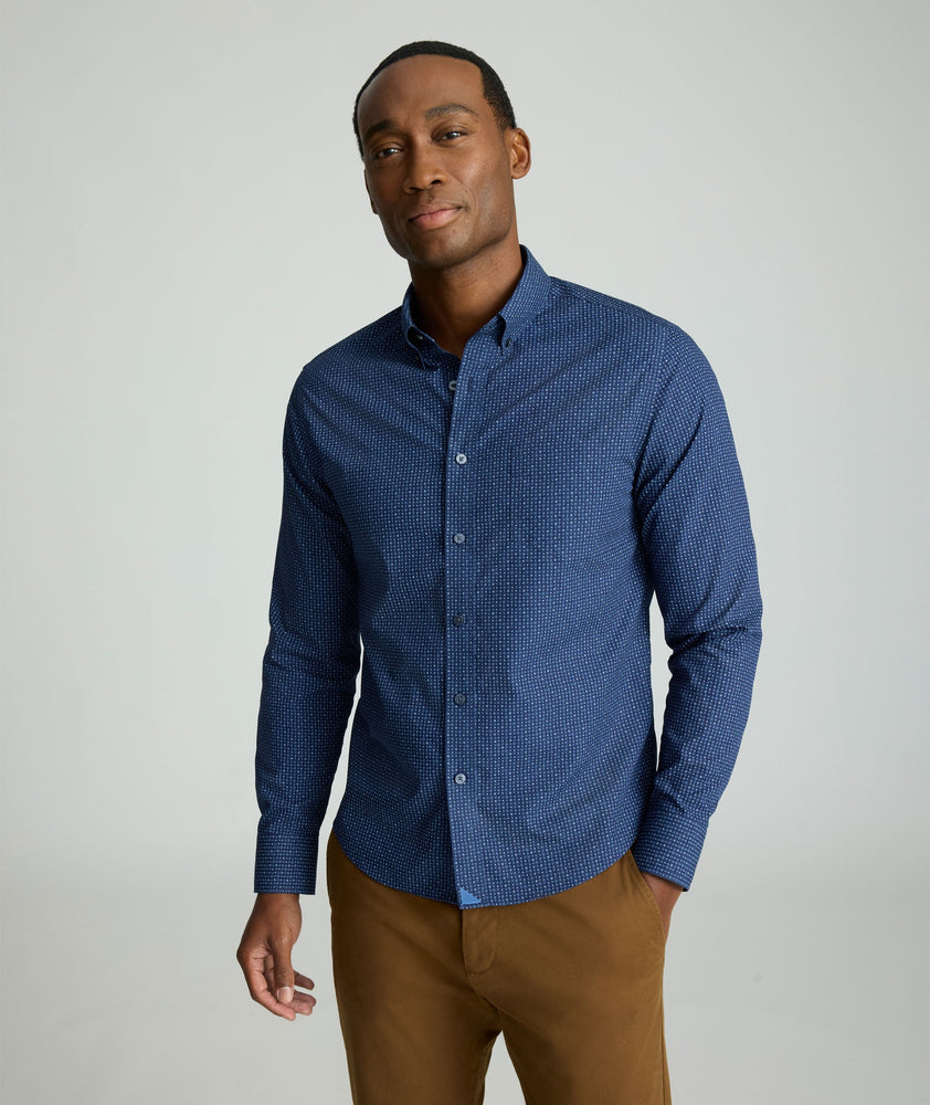 Model is wearing UNTUCKit Wrinkle-Free Cascadar Shirt in navy. 
