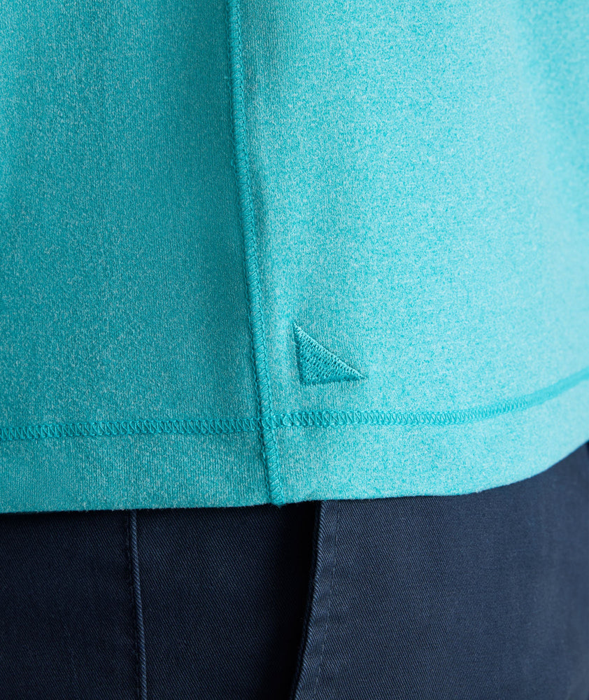 Model is wearing UNTUCKit Performance Polo in teal. 