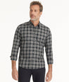 Model is wearing UNTUCKit Wrinkle-Free Devitt Shirt in Black Grounded Multi Plaid.