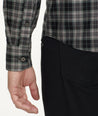 Model is wearing UNTUCKit Wrinkle-Free Devitt Shirt in Black Grounded Multi Plaid.